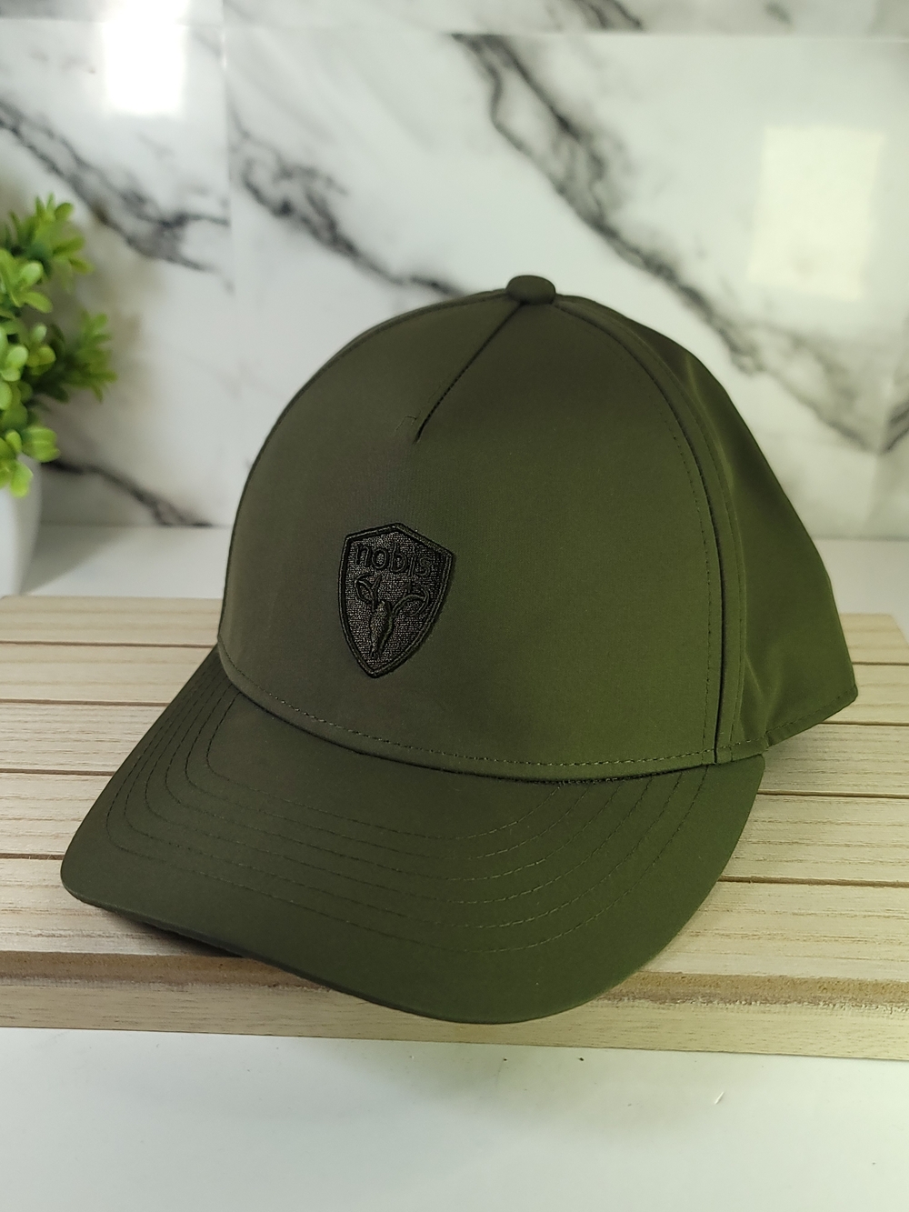Nobis Olive Green Baseball Cap with Black Embroidered Shield Log. Adjustable